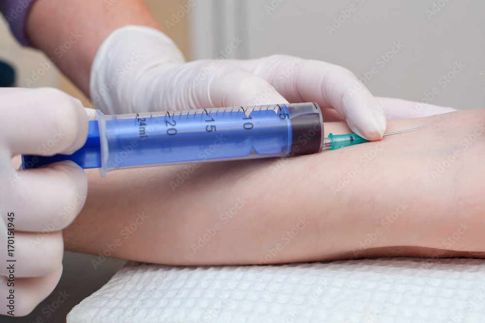 The doctor takes blood on the analysis.