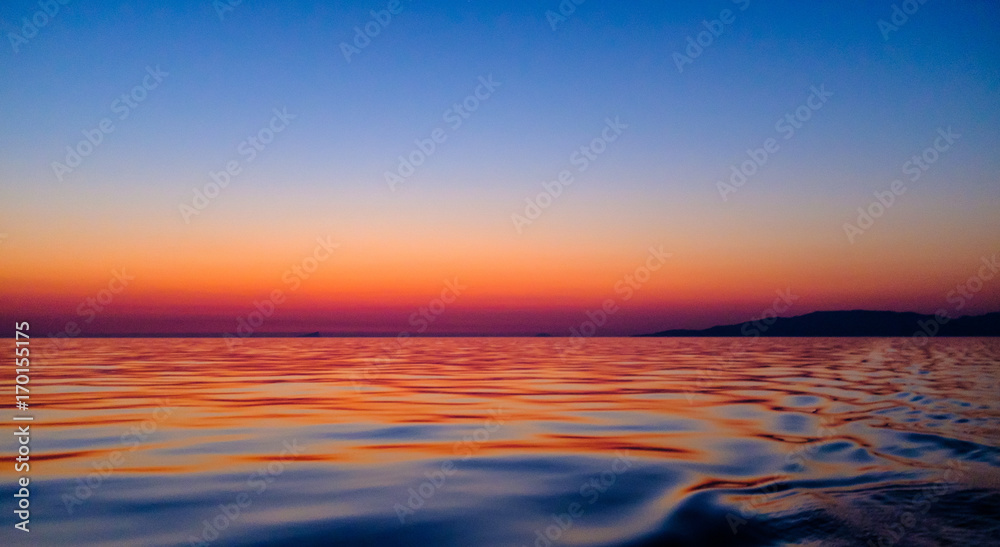 Sunrise from sailboat over the Aegean sea
