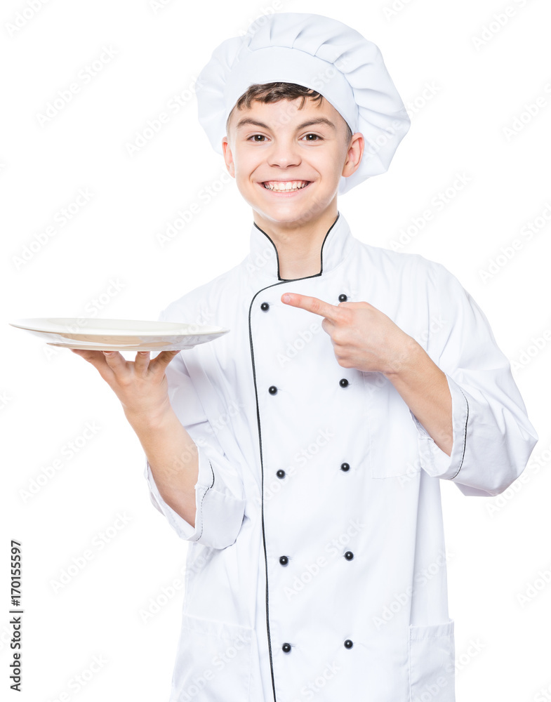 Cheerful handsome teen boy wearing chef uniform. Portrait of a happy cute male child cook with empty plate, isolated on white background. Food and cooking concept. Cheerful handsome teen boy wearing chef uniform. Portrait of a happy cute male child cook with empty plate, isolated on white background. Food and cooking concept.