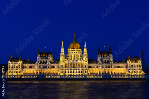 Night view of the illuminated building of the Hungarian Parliament in Budapest.