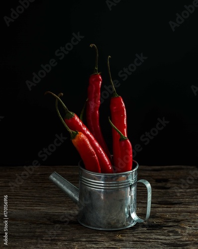 red chilly on wood background.low key