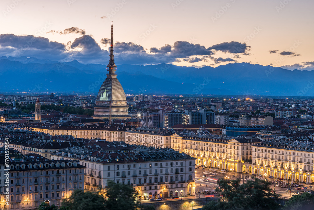 Torino Cityscape, Italia. Skyline panoramic view of Turin, Italy, at dusk with glowing city lights. The Mole Antonelliana illuminated, scenic effect.