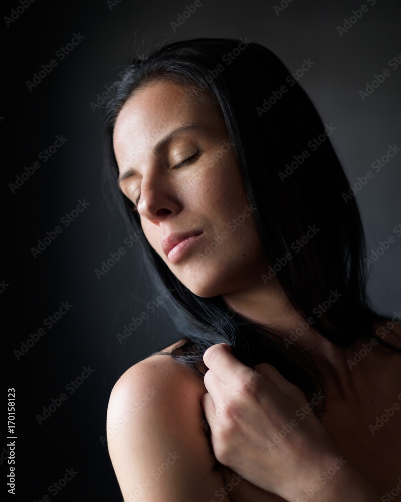 Fototapeta premium Studio portrait of caucasian woman with black long hair.