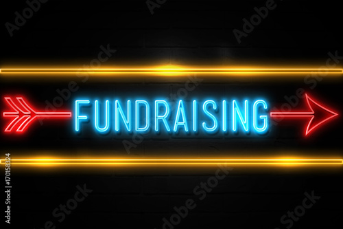 Fundraising  - fluorescent Neon Sign on brickwall Front view