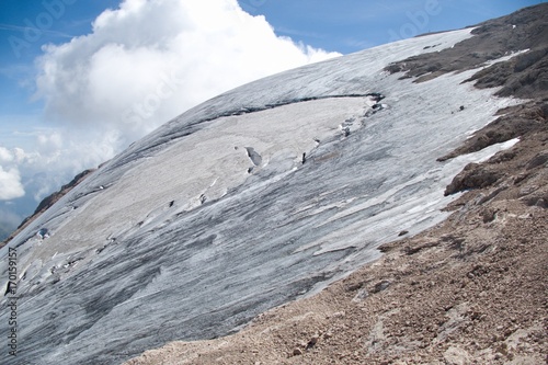 mountaineering in marmolada glacier in dolomites photo