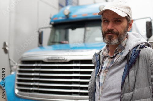 Mature man against truck