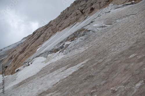 mountaineering in marmolada glacier in dolomites photo