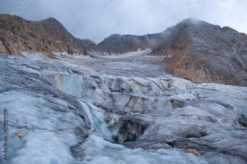 mountaineering in marmolada glacier in dolomites
