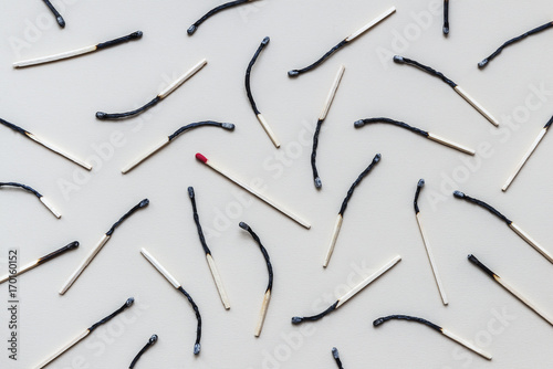 Image of seamless pattern of randomly arranged burned wooden matches with the preserved one among photo