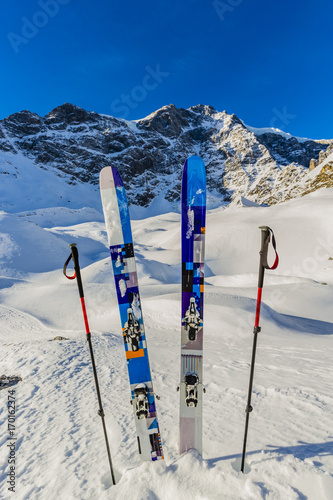 Ski in winter season  mountains and ski touring backcountry equipments on the top of snowy mountains in sunny day. South Tirol  Solda in Italy.
