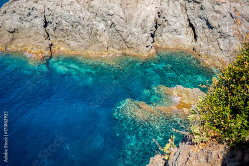 Cliffs in Bonassola, La Spezia province near 5 Terre, green and blue clean water of the mediterranean sea of ligurian east coast, Italy