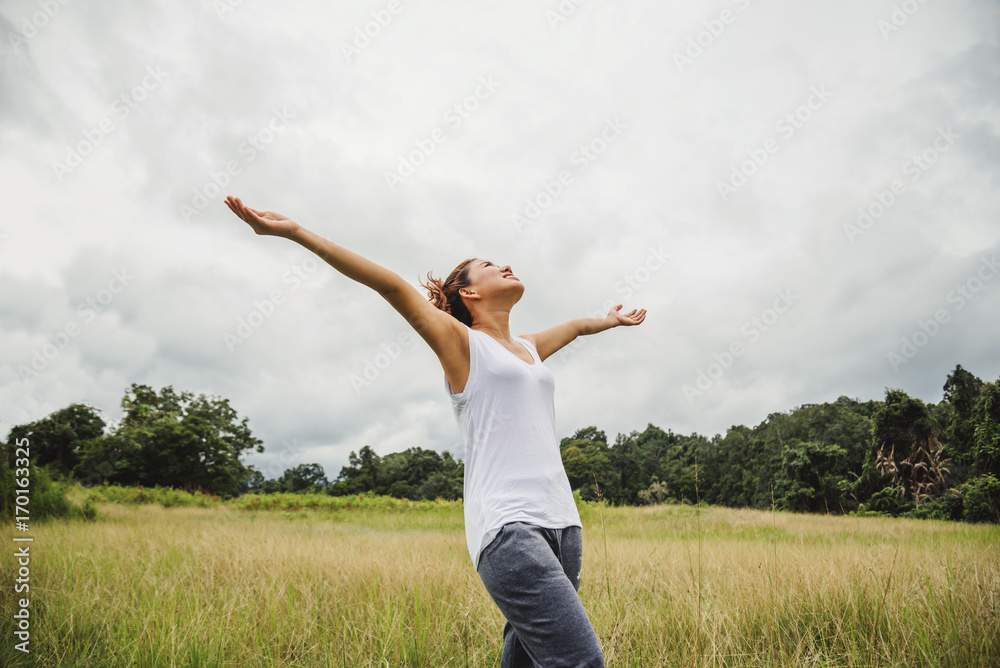 Asian women travel relax in the holiday. on a green pasture. Asian women travel relax in the holiday. on a green pasture.