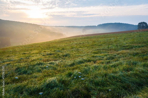 Sunrise over the fog on a field