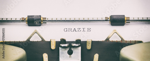 Grazie word in capital letters on white sheet