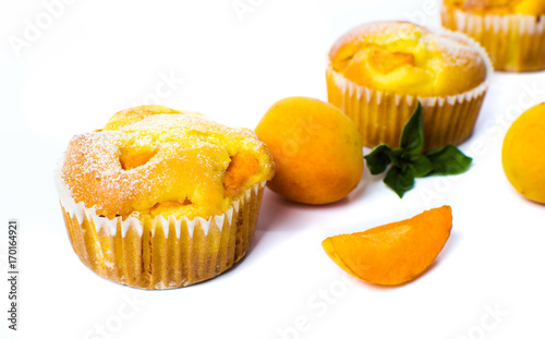 Apricot muffins with fresh fruit on white
