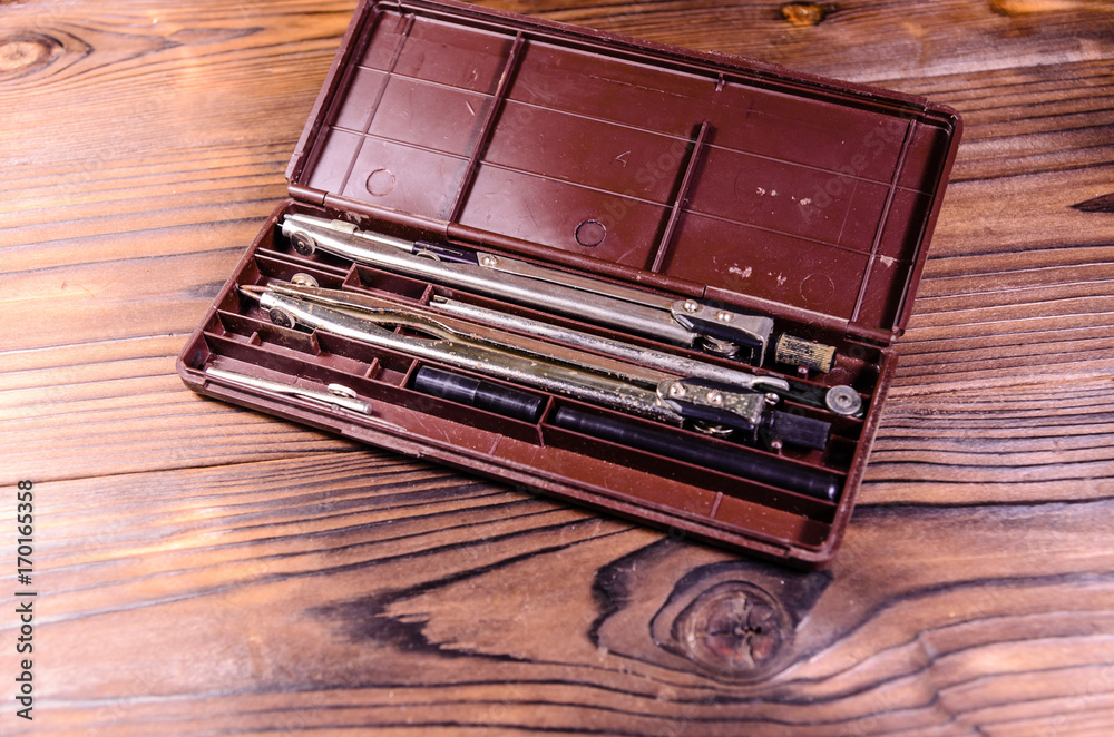 Case of drawing instruments on wooden table Case of drawing instruments on wooden table