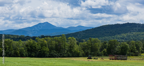 haying the fields  with view of Camels Hump Mountain , Green Mountains of Vermont
