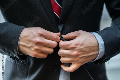 Businessman closing his suit