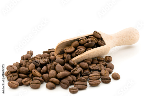 Coffee beans with a wooden shovel on white, isolated. photo