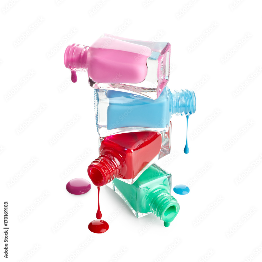 Stack of bottles with spilled nail polish isolated on white background