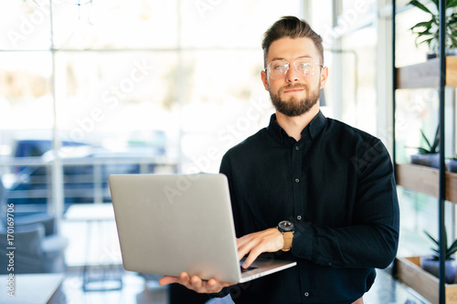 Young business man executive using laptop in office
