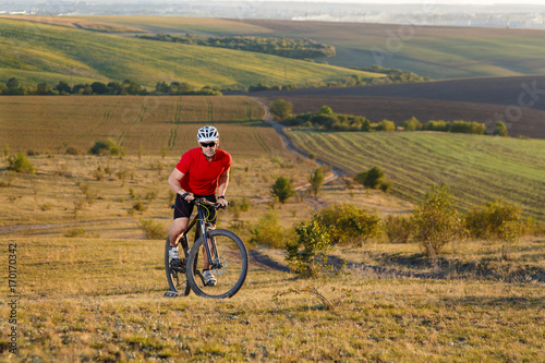 Traveler ride a bike on autumn background