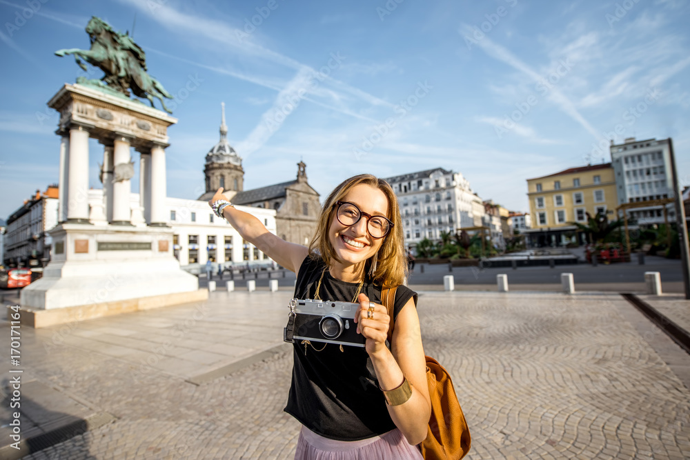 Fototapeta premium Portrait of a young woman tourist on the central square of Clermont-Ferrand square in France