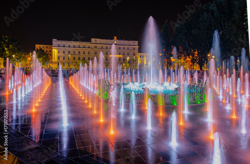 Night colorful fountain show inLublin park. Vivid color fountain water