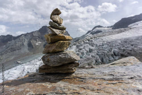 A beautiful cairn with mountains and a glacier in the background in the alps of switzerland.  © Benedikt