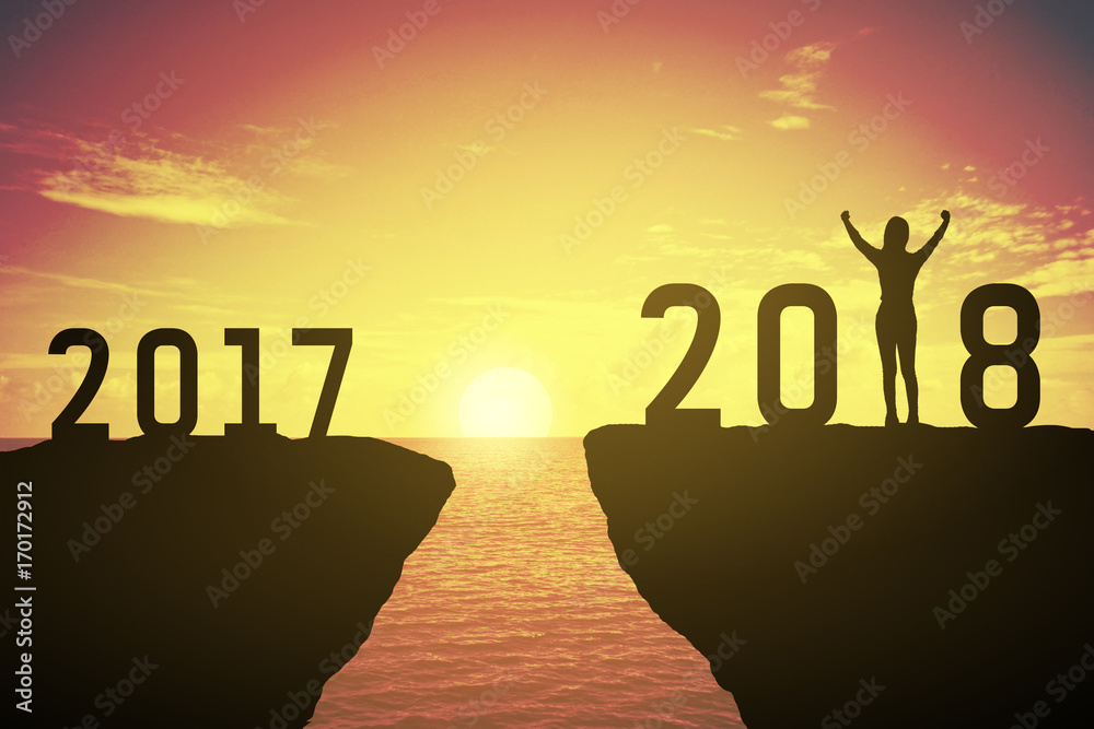 Silhouette of woman standing at 2018. 2017 and 2018 years. keep go on concept at 2018 over a beautiful sunset or sunrise at the sea. background for happy new years. success in 2018 years Silhouette of woman standing at 2018. 2017 and 2018 years. keep go on concept at 2018 over a beautiful sunset or sunrise at the sea. background for happy new years. success in 2018 years