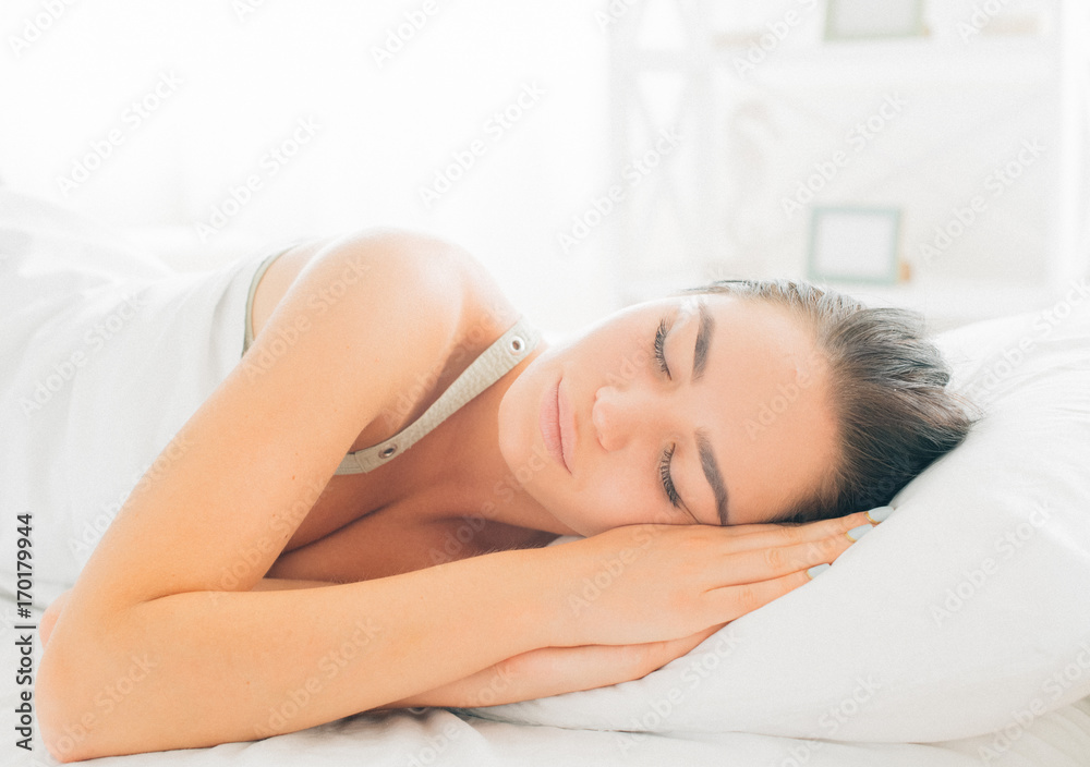 Beauty brunette girl sleeping in her comfortable bed Beauty brunette girl sleeping in her comfortable bed