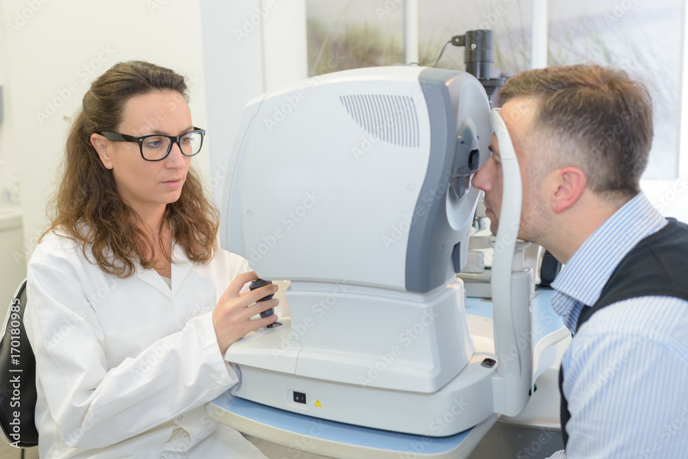 optometrist does an eye exam on patient optometrist does an eye exam on patient