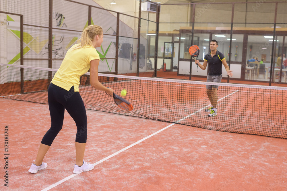 couple playing tennis game indoor tennis court couple playing tennis game indoor tennis court