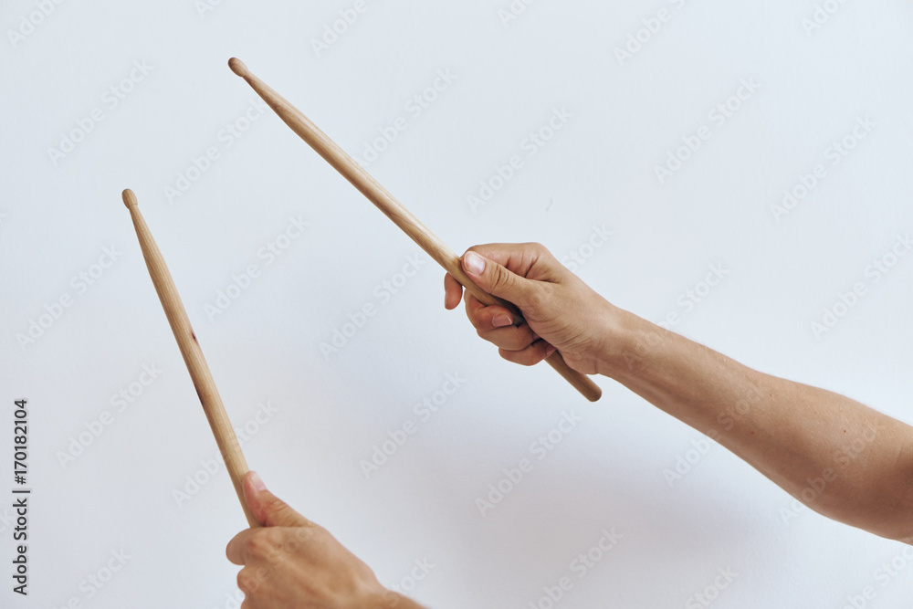 Fototapeta premium The hands hold the drumsticks