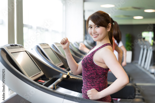 sporty asian women exercising in sports gym © taka