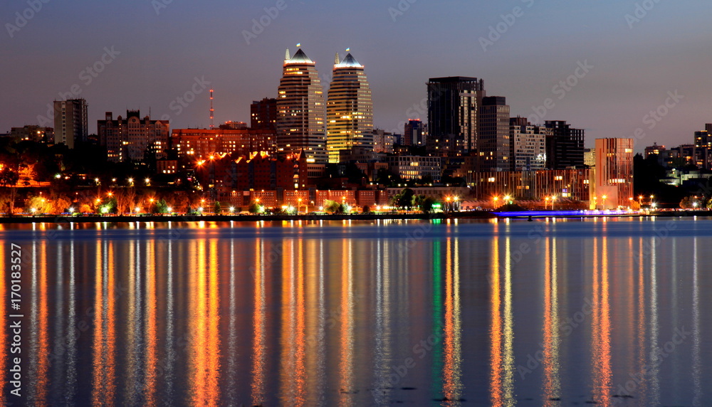 Fototapeta premium View of the Dnepr city at night, lights reflected on the river Dnieper, Ukraine, (Dnipro, Dnipropetrovsk, Dnepropetrovsk).