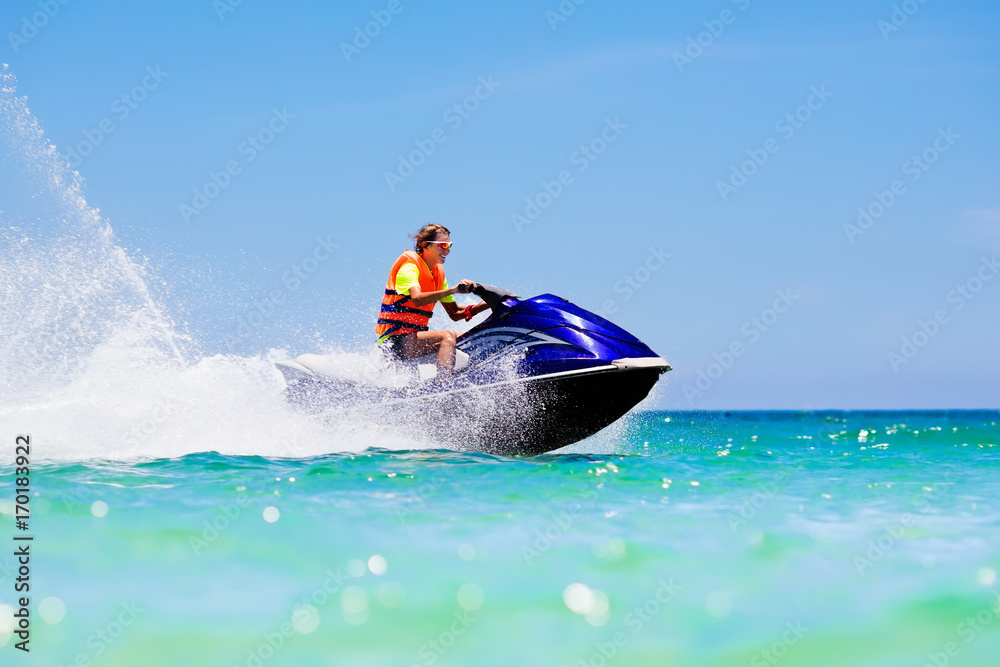 Teenager on water scooter. Teen age boy water skiing. Teenager on water scooter. Teen age boy water skiing.
