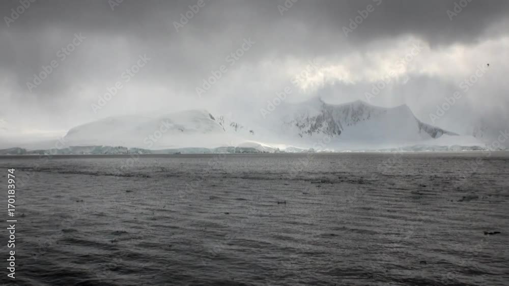 Snow coastline in ocean of Antarctica. Amazing unique beautiful wilderness nature and landscape of white mountains. Extreme tourism cold desert north pole. Snow coastline in ocean of Antarctica. Amazing unique beautiful wilderness nature and landscape of white mountains. Extreme tourism cold desert north pole.