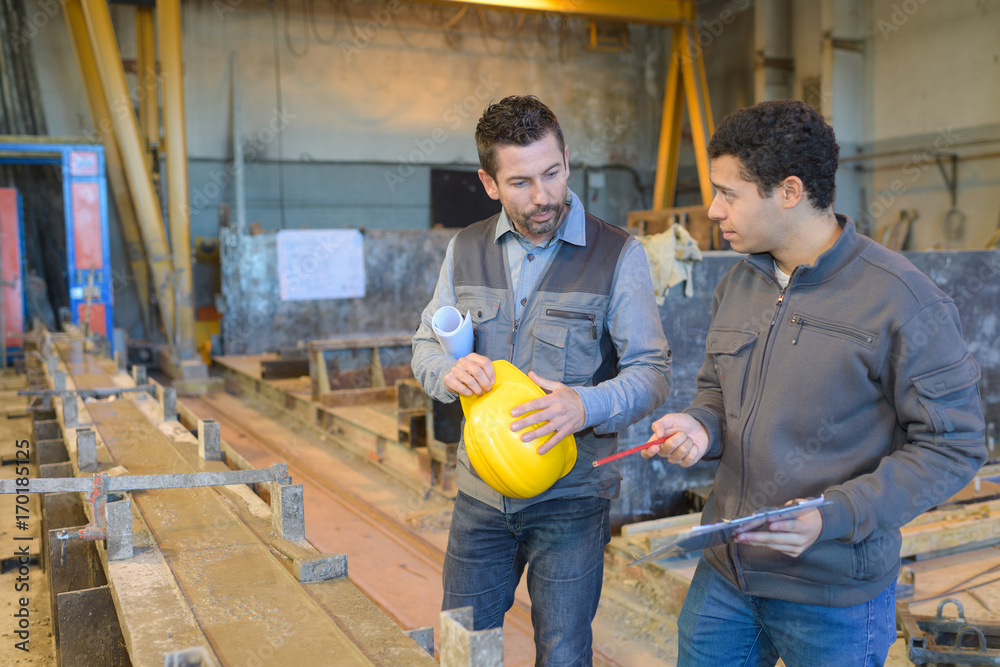 two businessman working in factory two businessman working in factory