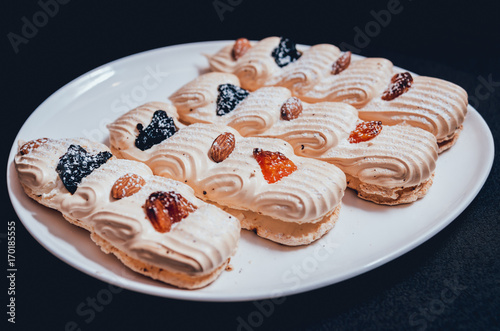 French meringue cookies on the white plate.