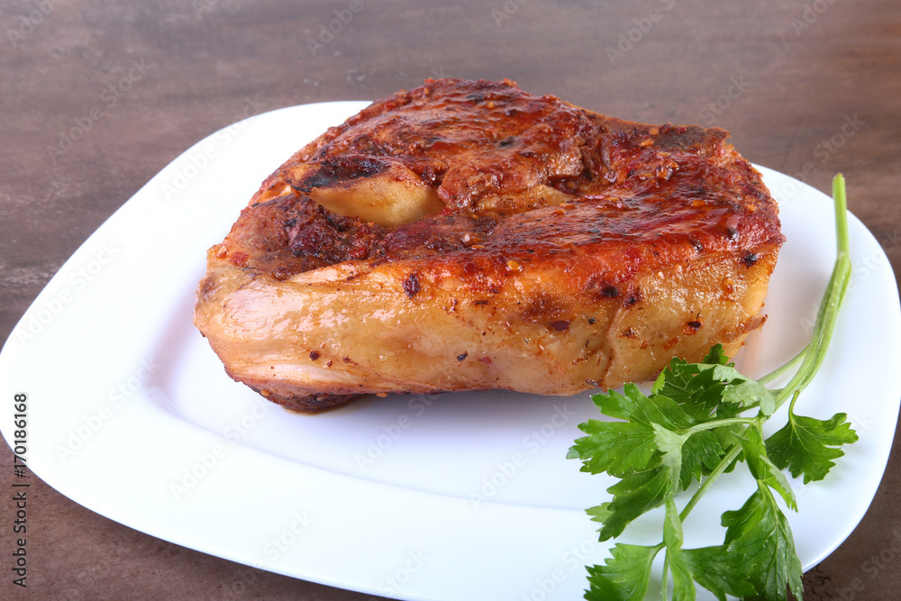 grilled pork chop with sauce on wooden table. grilled pork chop with sauce on wooden table.