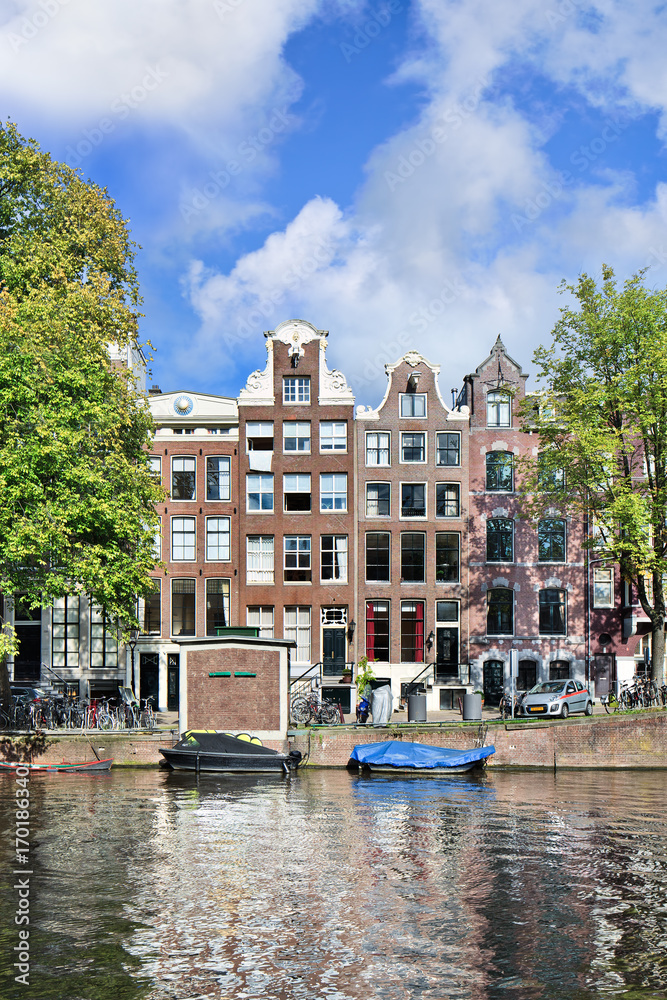 Ancient brick mansions in the Amsterdam historical canal belt.
