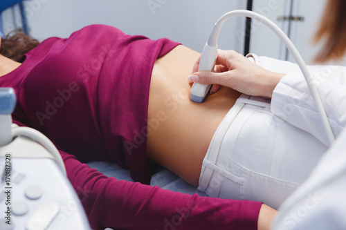 female doctor operating ultrasound scanner photo