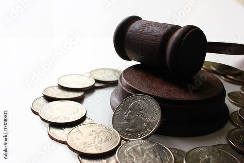 Obraz na plátně Hammer of a judge on a heap of dolor coins, a legal right