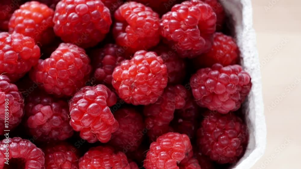 Fresh raspberry fruits in paper box. Healthy food organic nutrition. View from above. Dolly slider shot 4K ProRes HQ codec Fresh raspberry fruits in paper box. Healthy food organic nutrition. View from above. Dolly slider shot 4K ProRes HQ codec