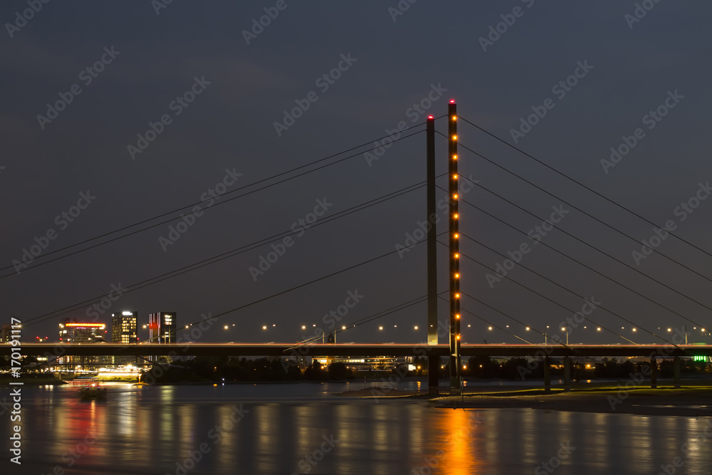 Night view of Rheinkniebrucke bridge and Rhine river. Long exposed image.