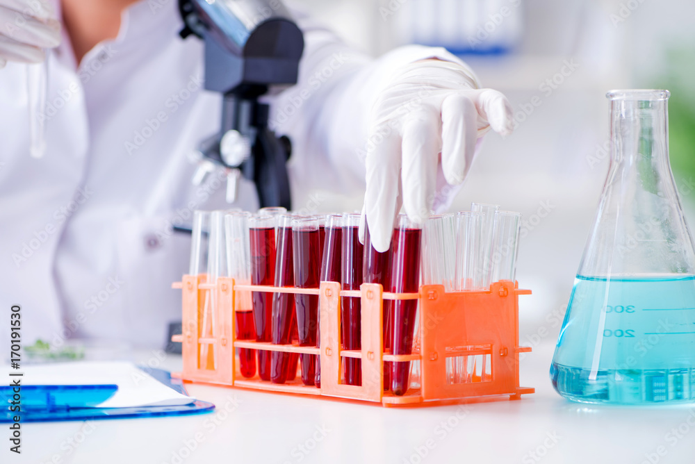 Fototapeta premium Female scientist researcher conducting an experiment in a labora