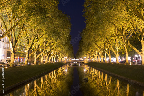 Night view of Stadtgraben by Konigsallee. A popular tourist attraction in Dusseldorf. Trees are illuminated. photo