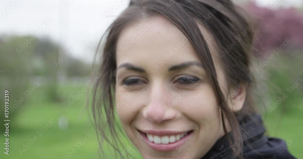 Attractive woman smiling and laughing up close on face - slow motion Attractive woman smiling and laughing up close on face - slow motion