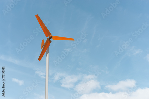 Colorful small wind turbine stand out the sky